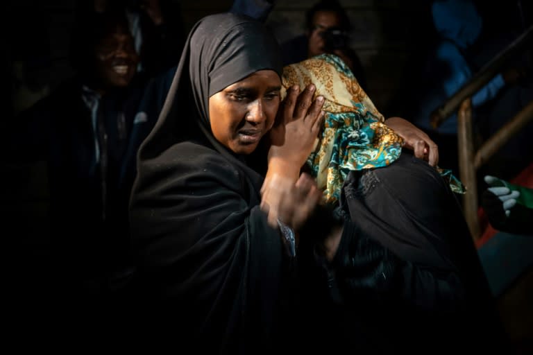 A woman is reunited with family after being evacuated from the DusitD2 compound in Nairobi