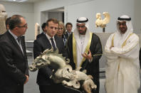 FILE - President-Director of the Louvre Museum Jean-Luc Martinez, left, French President Emmanuel Macron, 2nd left, Chairman of Abu Dhabi's Tourism and Culture Authority, Mohamed Khalifa al-Mubarak, 2nd right, and Abu Dhabi Crown Prince Mohammed bin Zayed al-Nahayan, right, visit the Louvre Abu Dhabi Museum during its inauguration in Abu Dhabi, United Arab Emirates, Wednesday, Nov. 8, 2017. Still reeling from the recent submarine deal rapture by Western allies, French President Emmanuel Macron is visiting the energy-rich Arab countries of the Persian Gulf on Friday Dec. 3, 2021, with an aim to close a lucrative arms deal and strengthen France's leadership role in renewed international efforts to revive Iran's cratered nuclear deal with world powers. (Ludovic Marin/Pool photo via AP, File)