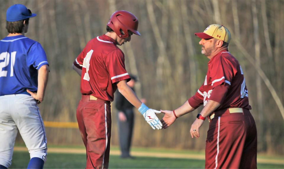 Portsmouth High School baseball coach Tim Hopley congratulates Joe Zingariello during Friday's 7-0 win over Salem