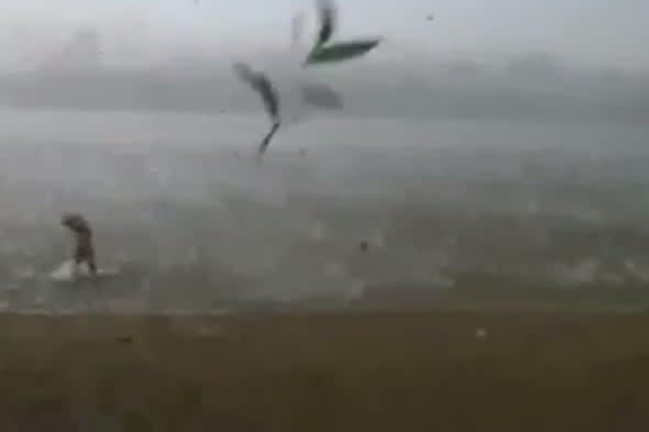 Swimmers flee as freak hail storm hits Siberian beach