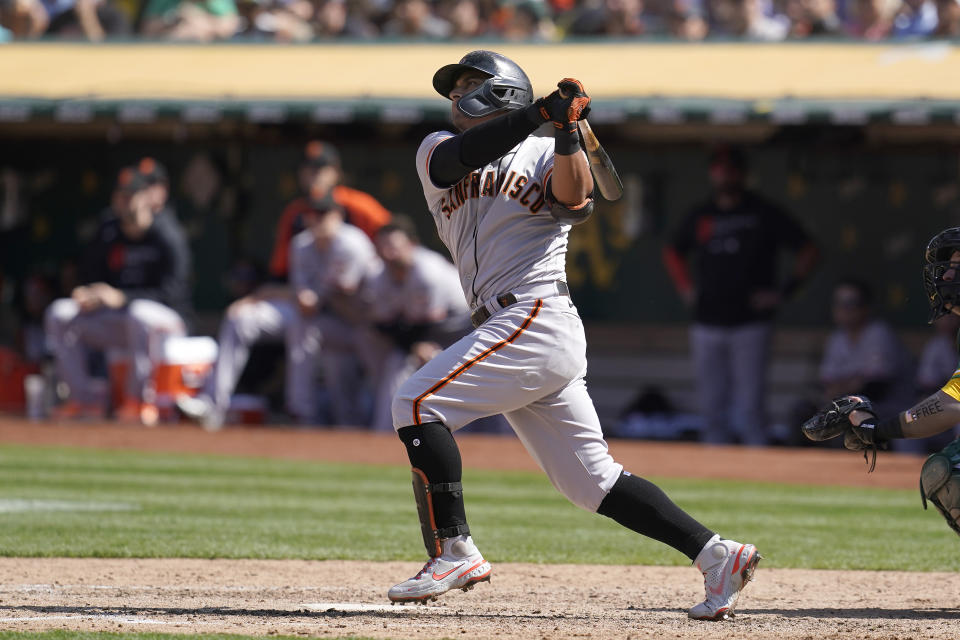 San Francisco Giants' Donovan Solano hits a two-run home run against the Oakland Athletics during the eighth inning of a baseball game in Oakland, Calif., Sunday, Aug. 22, 2021. (AP Photo/Jeff Chiu)