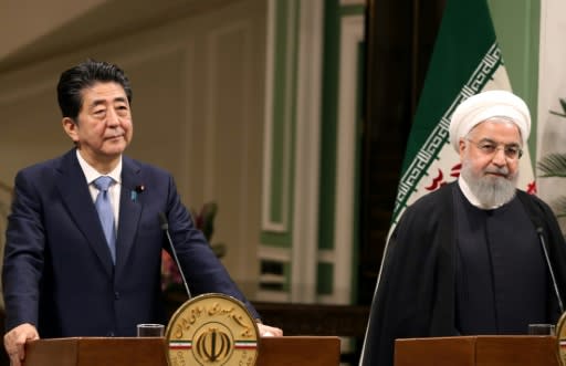 Iranian President Hassan Rouhani (R) gives a joint press conference with the Japanese Prime Minister Shinzo Abe in the capital Tehran on Wednesday