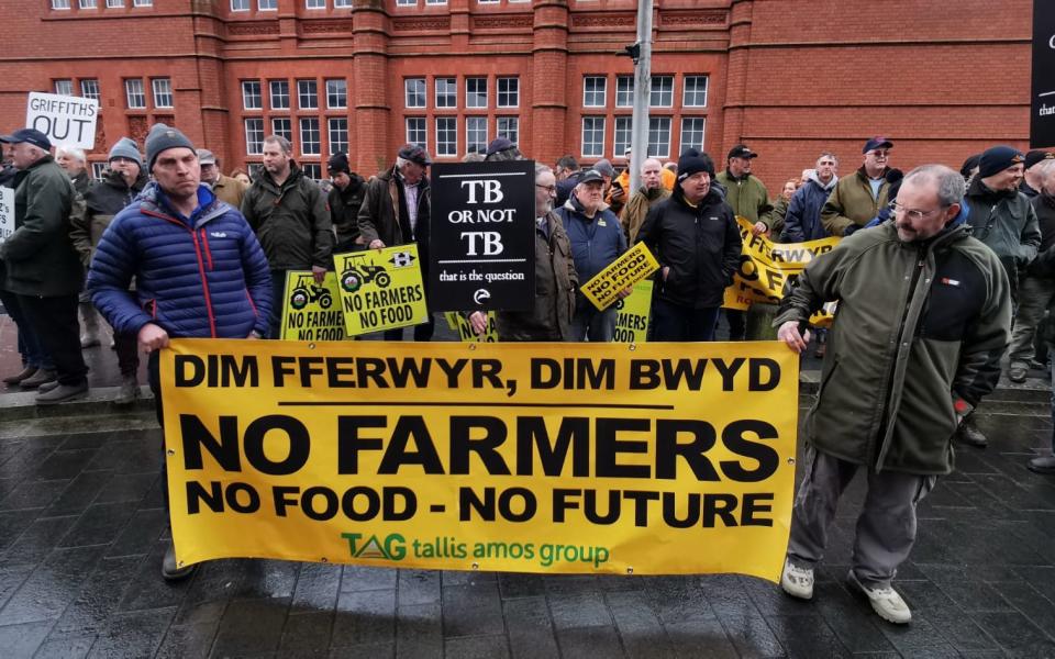 Protestors hold a sign reading 'No Farmers, No Food, No Future' during the demonstrations outside the Welsh Government building