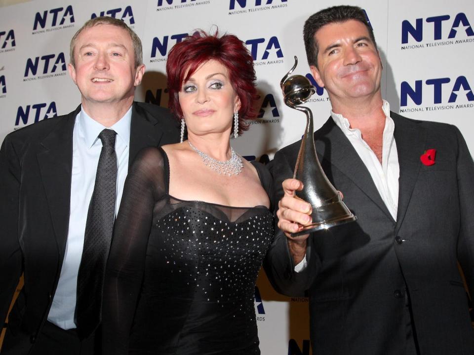 OCTOBER 31: Members of the "The X Factor" Louis Walshe, Sharon Osbourne and Simon Cowell pose with the award for Most Popular Talent Show at the National Television Awards 2007 held at the Royal Albert Hall on October 31, 2007 in London, England. (Photo by Jon Furniss/WireImage)