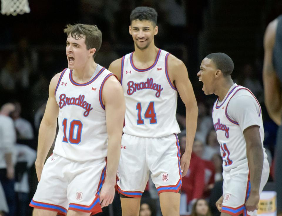 Bradley's Connor Hickman (10), Malevy Leons (14) and Duke Deen celebrate Hickman's three-pointer in overtime giving the Braves the lead over Illinois State on Wednesday, Jan. 25, 2023 at Carver Arena. The Braves held on to win 79-75.