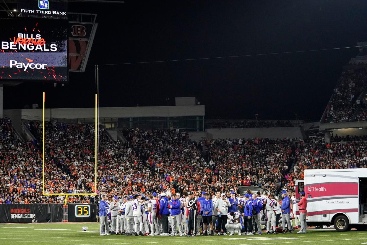 The Buffalo Bills players pray for teammate Damar Hamlin during the first half of an NFL football game against the Cincinnati Bengals, Monday, Jan. 2, 2023, in Cincinnati. The game has been postponed after Buffalo Bills' Damar Hamlin collapsed, NFL Commissioner Roger Goodell announced. (AP Photo/Joshua A. Bickel)