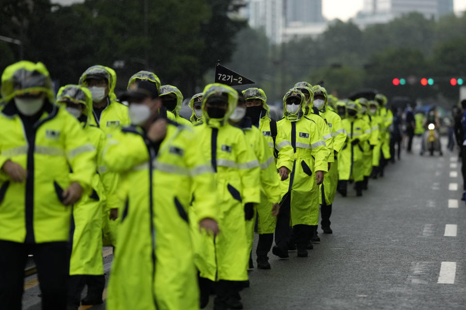 South Korean police officers walk during the 23rd Seoul Queer Parade in Seoul, South Korea, Saturday, July 16, 2022. Thousands of gay rights supporters celebrated under a heavy police guard in the South Korean capital on Saturday as they marked the city’s first Pride parade in three years after a COVID-19 hiatus. (AP Photo/Lee Jin-man)