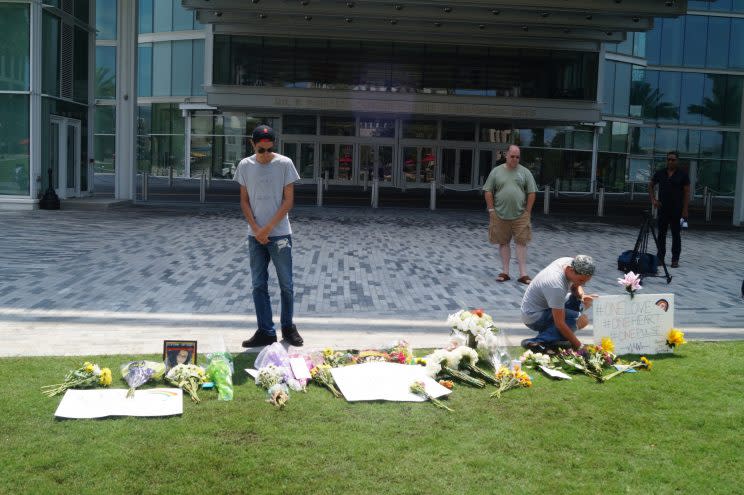 From left to right, James Carney Mercer, John Mullen and Josh Mercer honor Emmanuel Valentino at a memorial outside the Dr. Phillips Center for the Performing Arts in downtown Orlando on June 13, 2016. (Photo: Michael Walsh/Yahoo News)