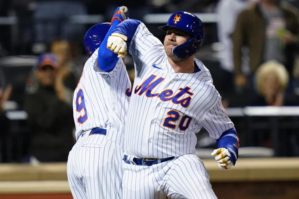 New York Mets' Pete Alonso, right, celebrates with Brandon Nimmo after Alonso hit a three-run home run during the fourth inning of the team's baseball game against the Miami Marlins on Tuesday, Sept. 27, 2022, in New York. (AP Photo/Frank Franklin II)