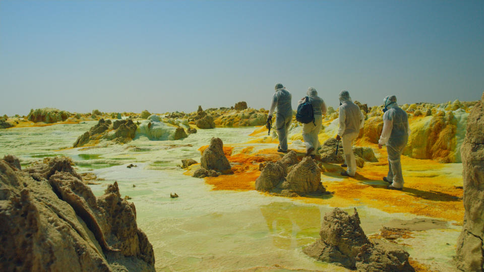 In this shot from "One Strange Rock," scientists&nbsp;walk through deadly acid pools near the Dallol volcano in Ethiopia.&nbsp; (Photo: National Geographic)