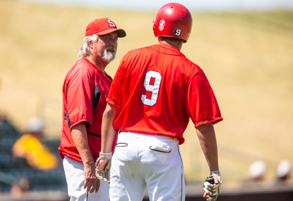 In this file photo, Springfield High baseball head coach Jim Steinwart comes out to talk with Griffin Burk (9) during the Class 3A state semifinals at Wintrust Field in Schaumburg, Ill., Thursday, June 17, 2021. [Justin L. Fowler/The State Journal-Register]