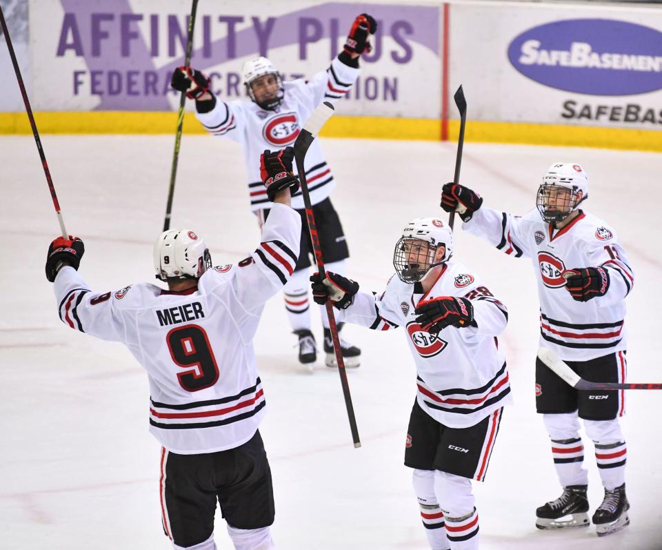 Players celebrate a goal by St. Cloud State's Spencer Meier during the first period of the Friday, Oct. 22, 2021, game at the Herb Brooks National Hockey Center in St. Cloud. Meier returns as captain for the Huskies this year.