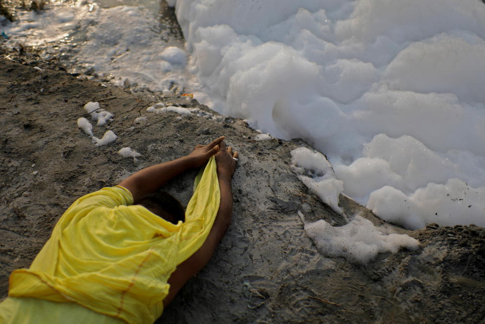 <p>A Hindu devotee worship the Sun god next to the foam covering the polluted Yamuna river during the Hindu religious festival of Chhath Puja in New Delhi, India, November 10, 2021. REUTERS/Adnan Abidi REFILE - CORRECTING FESTIVAL'S NAME TPX IMAGES OF THE DAY</p> 