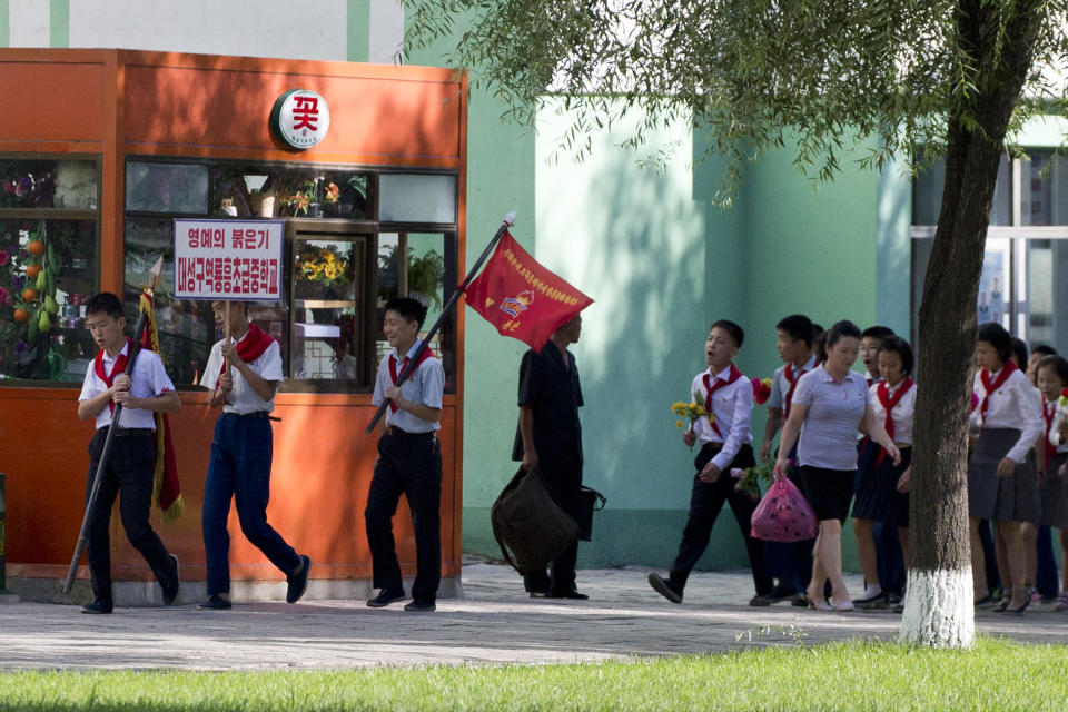 School children march in a group as the capital prepares for the 70th anniversary of North Korea's founding day in Pyongyang, North Korea, Friday, Sept. 7, 2018. North Korea will be staging a major military parade, huge rallies and reviving its iconic mass games on Sunday to mark its 70th anniversary as a nation. (AP Photo/Ng Han Guan)