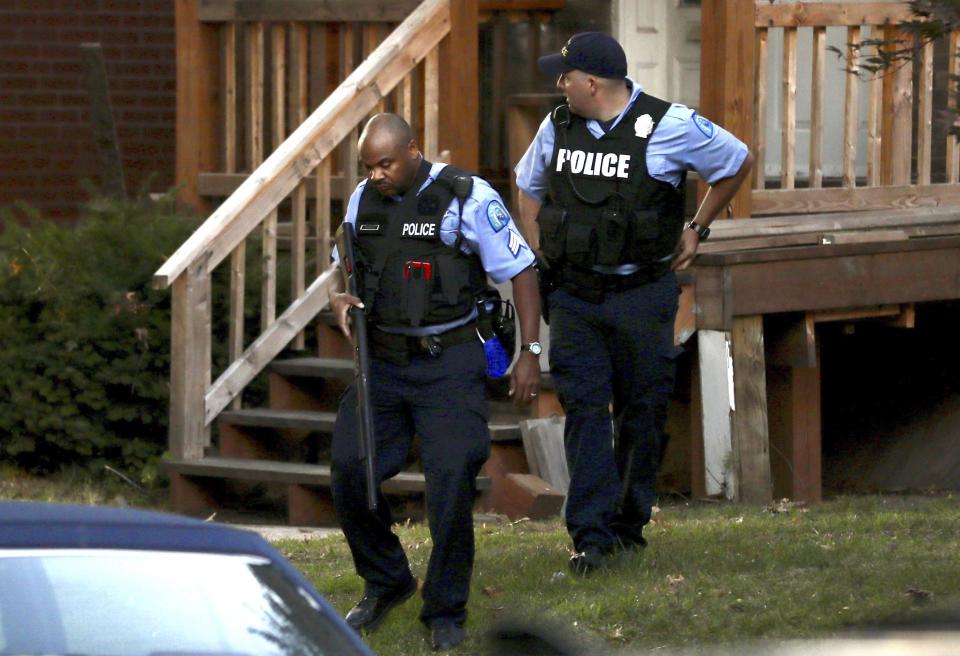 Members of the St. Louis Police Department work near the scene of a shooting Saturday, Aug. 29, 2020, in St. Louis. Two police officers have been shot and a suspect is believed to be barricaded in a house nearby according to the St. Louis Police Department. (David Carson/St. Louis Post-Dispatch via AP)