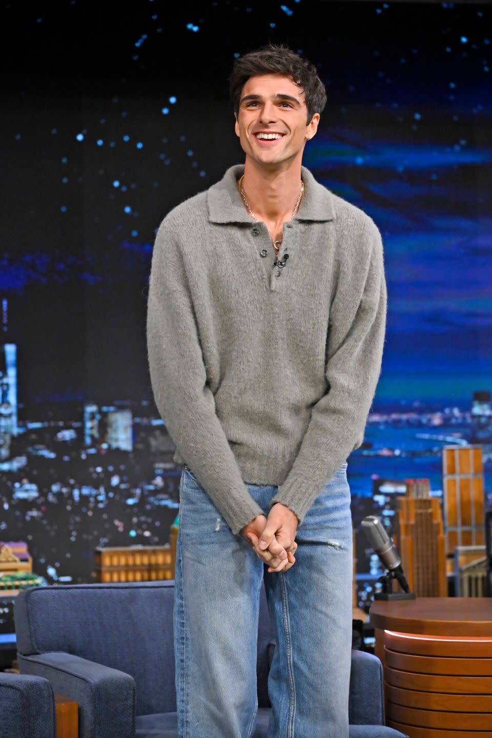 a man standing in front of a stage with a microphone