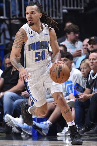 <p>Gary Bassing/NBAE via Getty</p> Cole Anthony of the Orlando Magic dribbles the ball during the game against the Cleveland Cavaliers on April 4, 2023 at Amway Center in Orlando, Florida