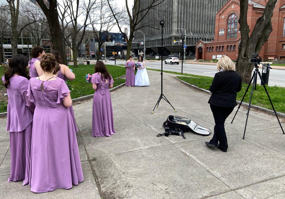 Rebecca Lassey-Ryan gets photos made with her bridesmaids outside St. Mary's Catholic Church in Rochester. She got married during the eclipse window and the congregation went outside to see the day darken.