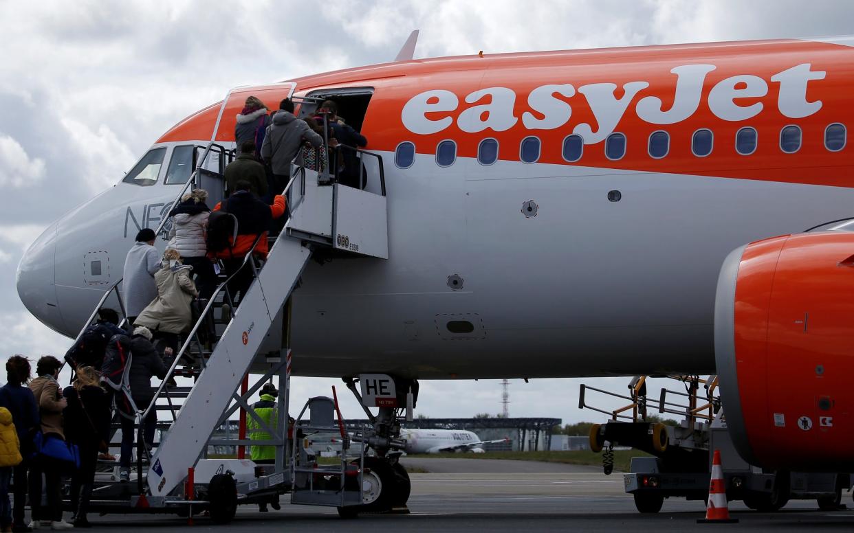 Passengers board an easyJet plane