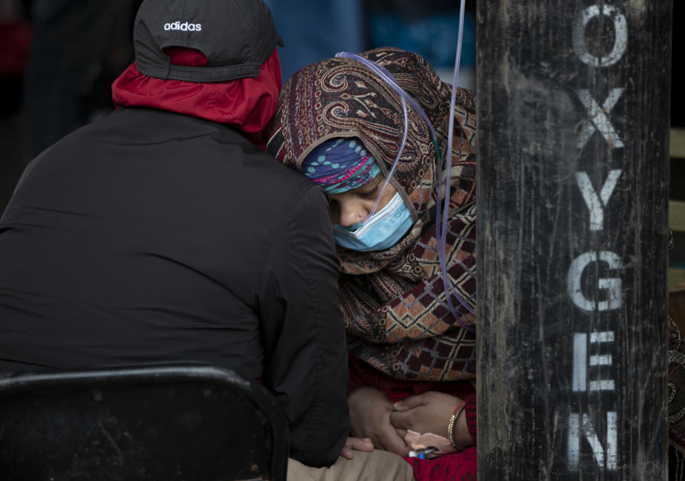 A COVID-19 patient receives oxygen outside an emergency ward at a government run hospital in Kathmandu, Nepal, Thursday, May 13, 2021. (AP Photo/Niranjan Shrestha)