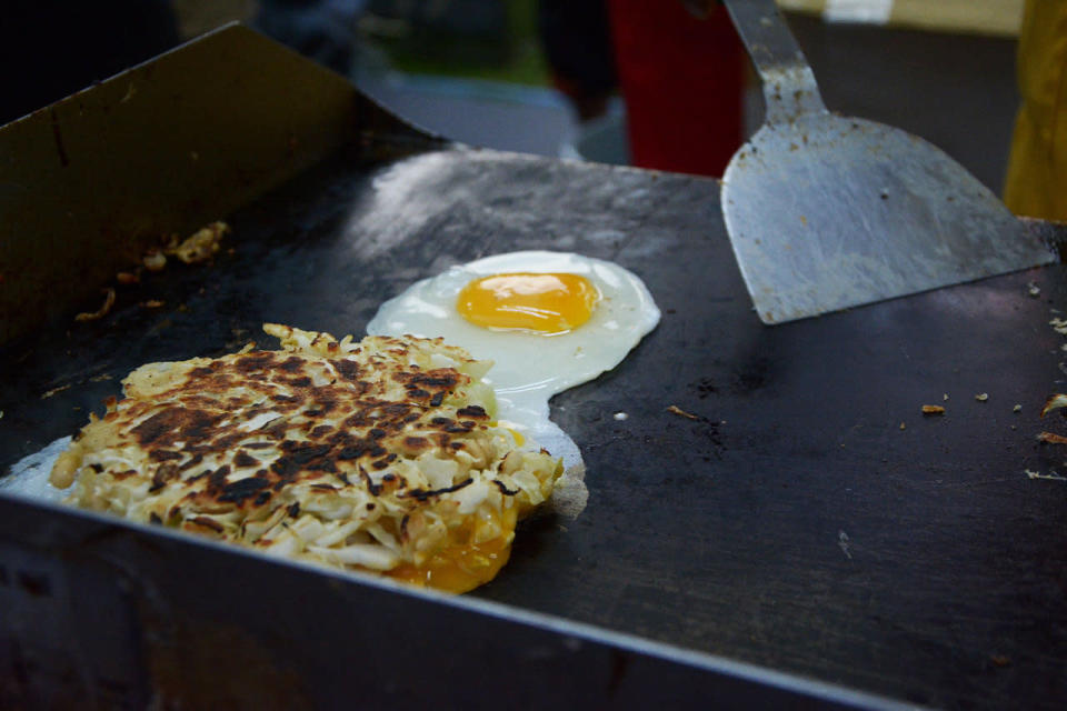 Okonomiyaki, a Japanese pancake made from eggs and shredded cabbages, being grilled. (Photo: Sharlene Sankaran/Yahoo Singapore)