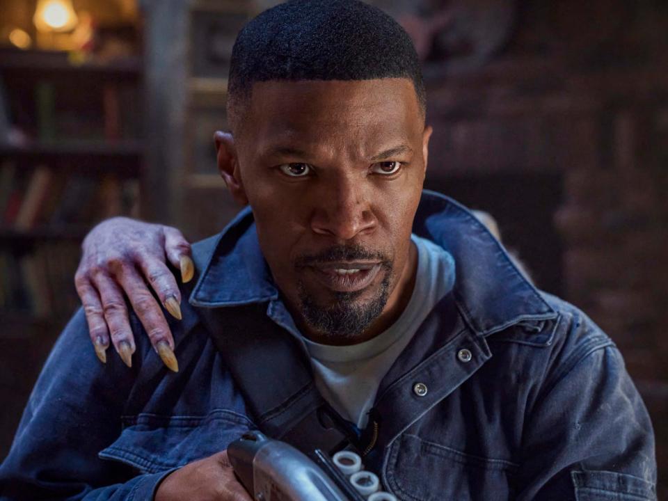 Jamie Foxx with a vampire hand on his shoulder