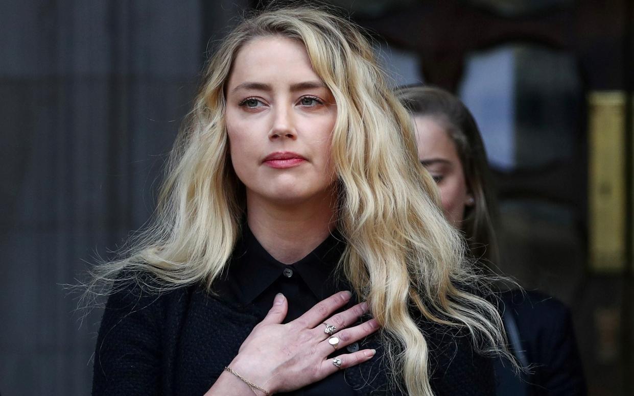Actress Amber Heard delivers a statement after winning her case at the High Court in London, - Reuters