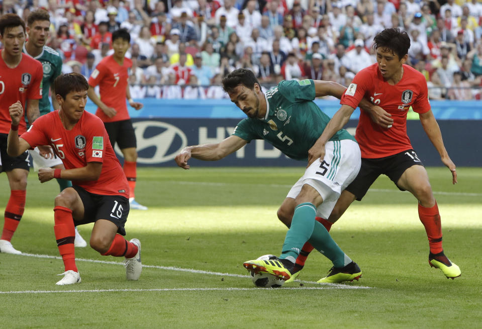 <p>Germany’s Mats Hummels, center, challenges for the ball with South Korea’s Koo Ja-cheol, right, and Jung Woo-young </p>