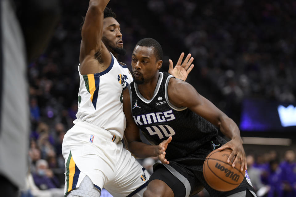 Utah Jazz guard Donovan Mitchell, tries to stop the drive of Sacramento Kings forward Harrison Barnes during the first quarter of an NBA basketball game in Sacramento, Calif., Friday, Oct. 22, 2021. (AP Photo/Jose Luis Villegas)