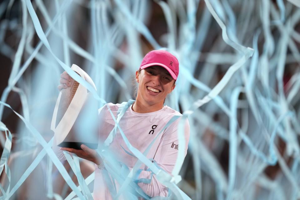 Poland's Iga Swiatek holds the trophy after winning the women's final match against Aryna Sabalenka of Belarus, at the Mutua Madrid Open tennis tournament in Madrid, Spain, Saturday, May 4, 2024. (AP Photo/Bernat Armangue)