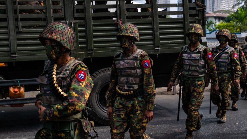 Myanmar military soldiers stand guard after arriving overnight with armoured vehicles on February 15, 2021 near the Central Bank in Yangon, Myanmar.