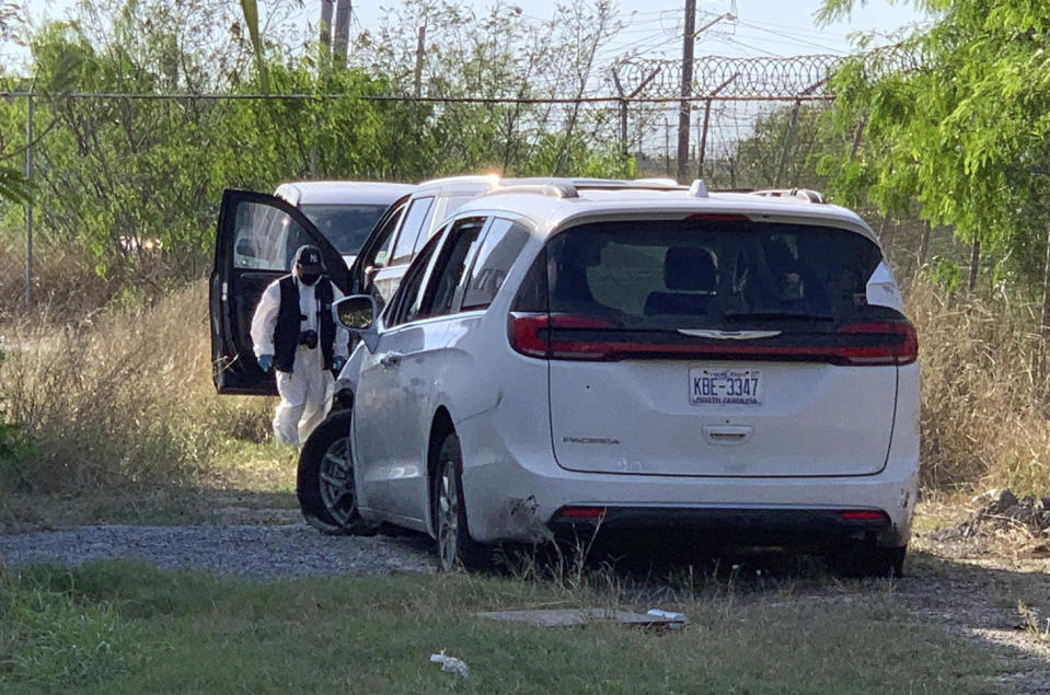 A Mexican police investigator inspects the minivan were four Americans where shot and taken from last week, at the Tamaulipas State Prosecutor´s headquarters in Matamoros, Mexico, Wednesday, March 8, 2023. Their minivan crashed and was fired on shortly after they crossed into the border city of Matamoros on Friday as drug cartel factions tore through the streets, the region's governor said. A stray bullet also killed a Mexican woman about a block and a half away. (AP Photo)