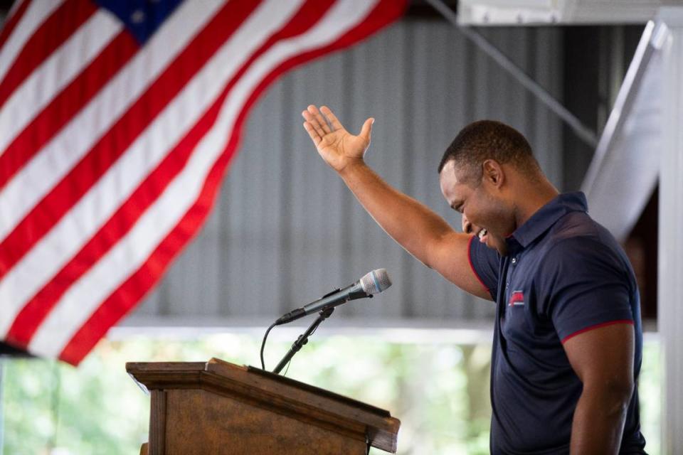 Kentucky Attorney General, and candidate for Governor, Daniel Cameron waves to part of the crowd booing as he takes the podium to speak during the 142nd annual St. Jeromes Fancy Farm Picnic before politicians deliver speeches in Fancy Farm, Ky., Saturday, August 6, 2022.