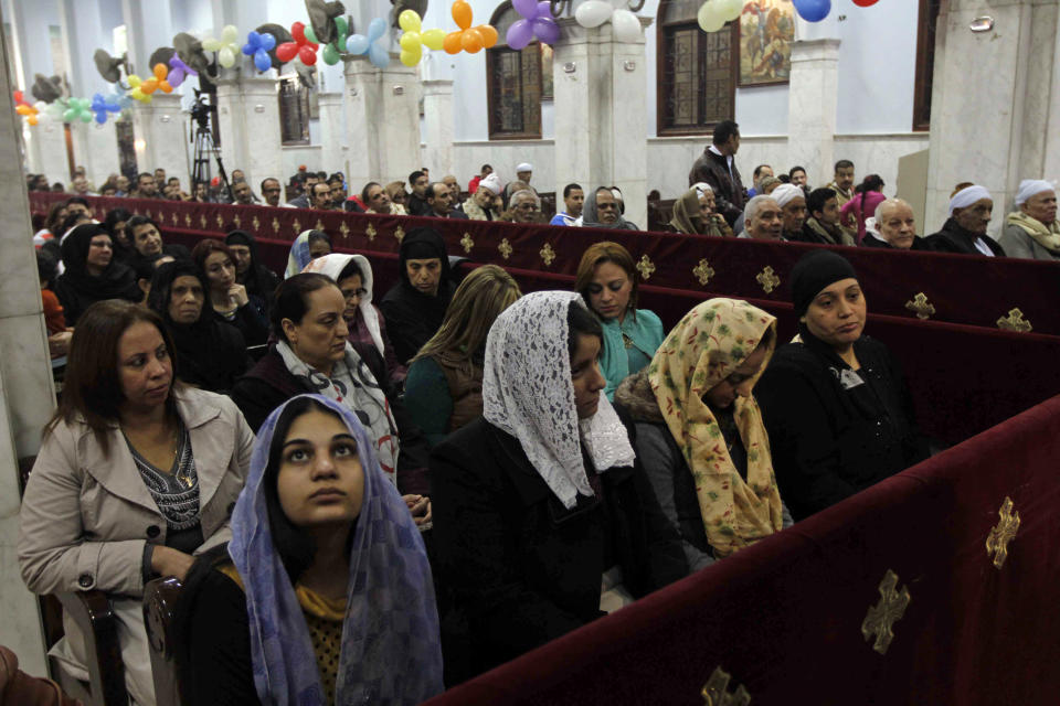 Worshippers attend Christmas Eve Mass, where an Oct. 2013 deadly drive-by-shooting killed several at a wedding party, at the Coptic Orthodox Virgin Mary Church in the Warraq neighborhood of Cairo, Egypt, Monday Jan. 6, 2014. Millions of Egyptian Christians on Monday thronged churches across the mainly Muslim nation for Christmas Mass, held amid unusually tight security but with congregations filled with hope ahead of a key vote this month on constitutional amendments that enshrine equality and criminalize all types of discrimination. (AP Photo/Ravy Shaker, El Shorouk Newspaper) EGYPT OUT