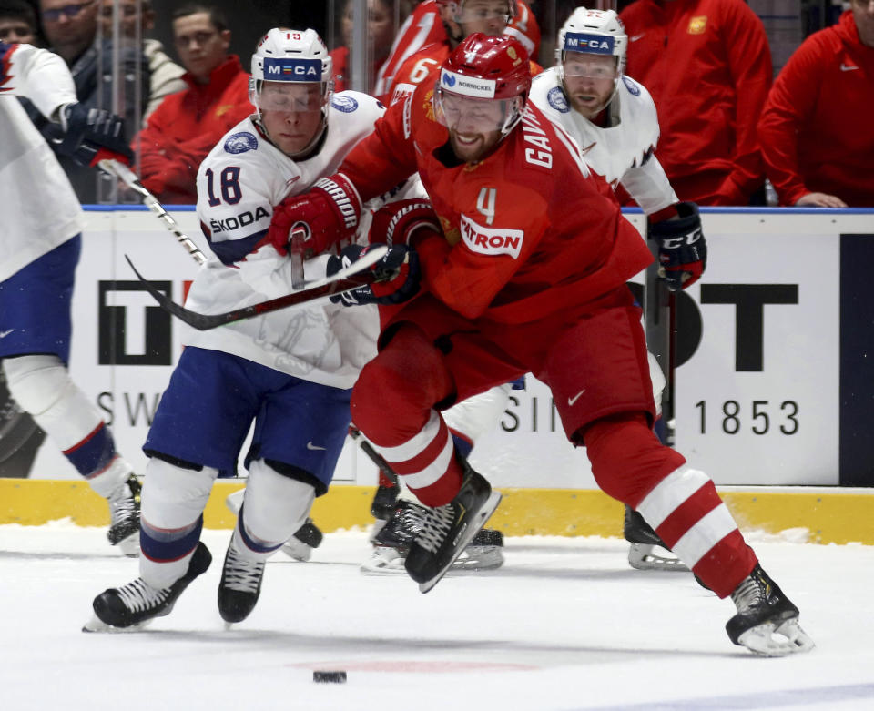 Norway's Tobias Lindstroem, left, checks Russia's Vladislav Gavrikov during the Ice Hockey World Championships group B match between Russia and Norway at the Andrej Nepela Arena in Bratislava, Slovakia, Friday, May 10, 2019. (AP Photo/Ronald Zak)