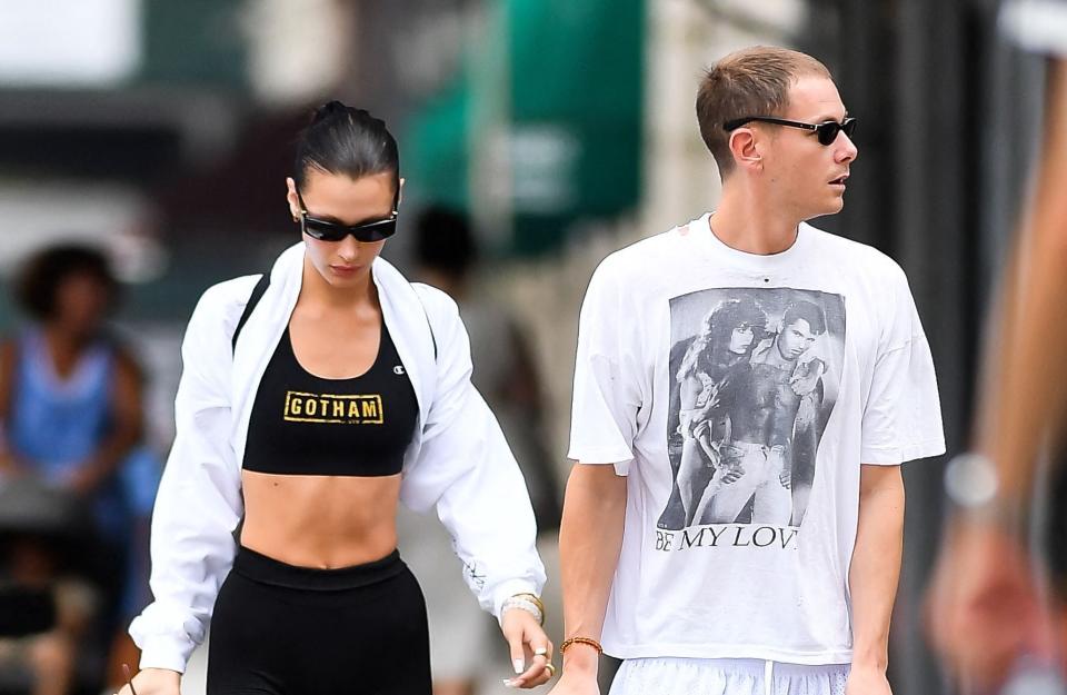 New York, nouvelle ville de l’amour ? Après la balade en amoureux de Jennifer Lopez et Ben Affleck au cœur de la métropole américaine, c’est Bella Hadid et le directeur artistique, Marc Kalman, qui ont été vus, ce 9 août 2022. La petite sœur de Gigi Hadid apparaît heureuse au bras de son compagnon, près de trois ans après sa rupture avec The Weeknd. Amoureuse, de nouveauBella Hadid était la compagne et muse du chanteur The Weeknd de 2015 à 2019. Malgré les nombreuses ruptures, le couple semblait toujours se retrouver, jusqu’en août 2019, où le duo se sépare pour de bon. D’après des sources proches du chanteur, leurs emplois du temps respectifs ne leur permettaient pas de se donner à 100% dans leur relation amoureuse. Voir cette publication sur Instagram Une publication partagée par Bella (@bellahadid) Depuis 2021, c’est dans les bras du directeur artistique, Marc Kalman, que la cadette du clan Hadid a retrouvé l’amour. Le duo avait fait leur première apparition publique en février 2022 : alors que Bella Hadid ouvrait le défilé Fendi pour la Fashion Week de Milan, automne-hiver 2022-2023, son compagnon avait fait le déplacement pour la soutenir. Mais le mannequin, récente fondatrice de « Kin Euphorics », aime partager son amour pour son chéri via Instagram. En juillet 2021, Bella Hadid partageait sur la Toile un premier cliché du duo. L’américano-palestinienne enlaçait son petit-ami sur la photo et écrivait que cette période de sa vie était la meilleure de toutes, étant « en bonne santé, travaillant et aimée. » Vu de nombreuses fois en rendez-vous galant à New York, comme en février dernier, le couple semble passer tout leur temps libre ensemble. À l’occasion de cette nouvelle balade en public, Bella Hadid portait un cycliste noir, un crop top Gotham Gym, une simple veste blanche et des baskets Givenchy. Un look qui lui ressemble. Découvrez les photos dès maintenant.