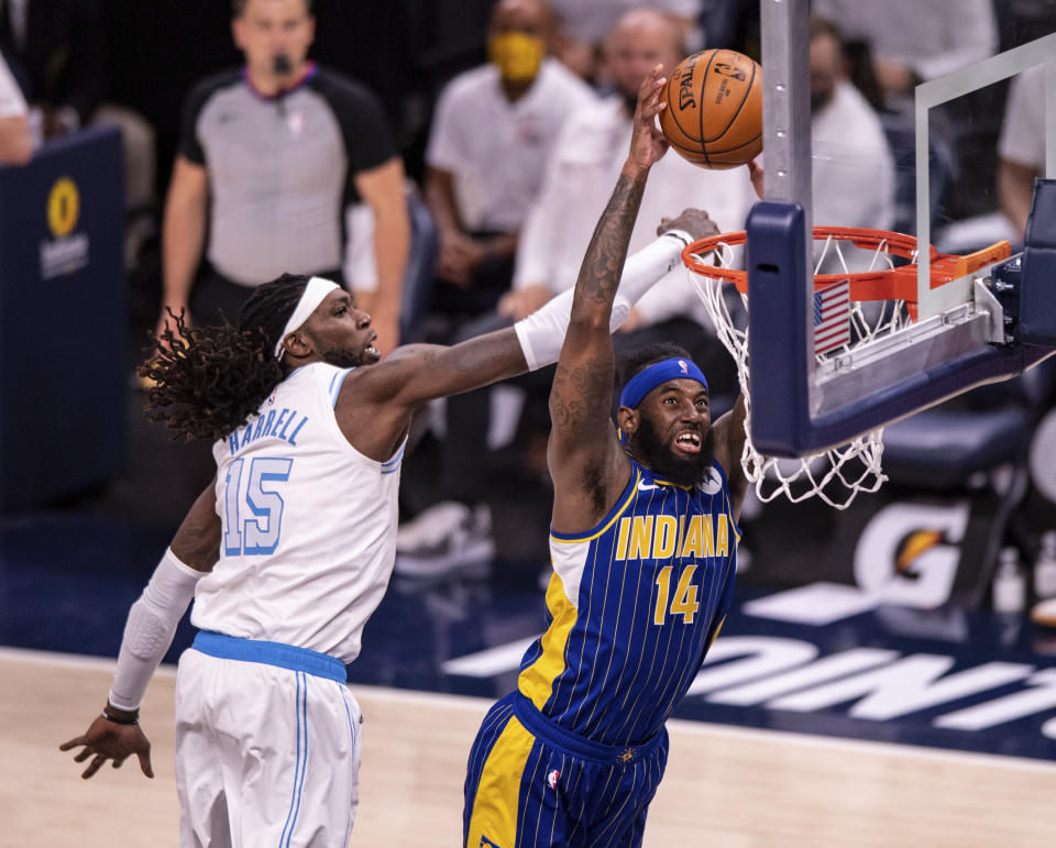 Indiana Pacers forward JaKarr Sampson (14) scores while Los Angeles Lakers center Montrezl Harrell (15) defends during the second half of an NBA basketball game in Indianapolis, Saturday, May 15, 2021. (AP Photo/Doug McSchooler)