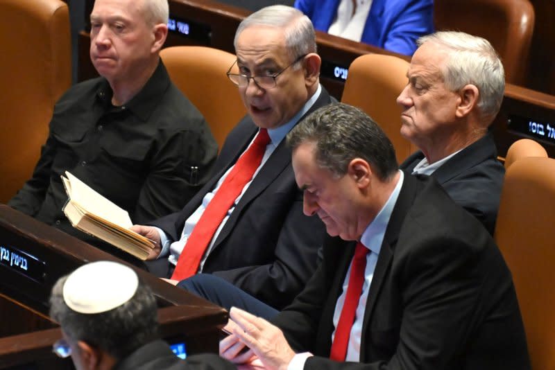 Israeli Prime Minister Benjamin Netanyahu sits with Defense Mnister Yoav Gallant (L) and Benny Gantz (R), member of the war cabinet, in the Knesset on Wednesday. Photo by Debbie Hill/UPI