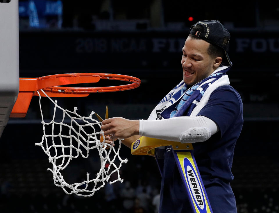 Villanova’s Jalen Brunson cuts the net as he celebrates after the championship game of the Final Four NCAA college basketball tournament against Michigan. Villanova won 79-62. (AP)