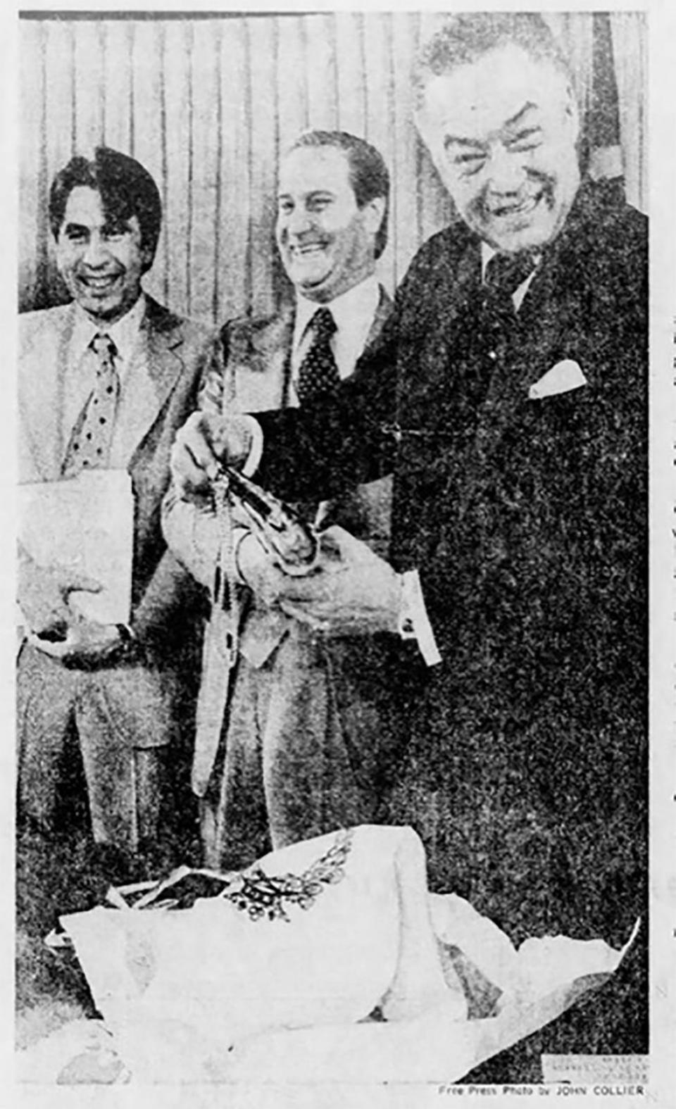 Mayor Young receives a gift purse — for his female companion — from the mayor of Florence, Italy, Elio Gabbugiani, center. The man at left was an Italian official.