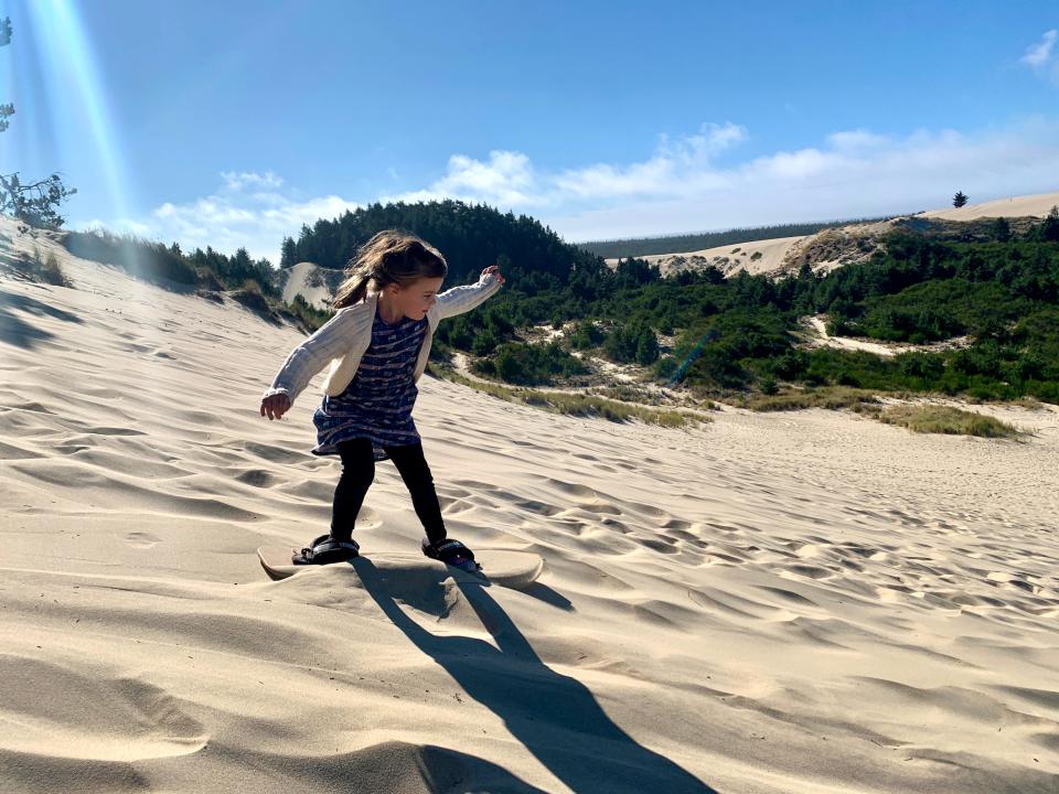 Rollie Urness, 5, sandboards down the dunes at Honeyman State Park on the Oregon Coast.