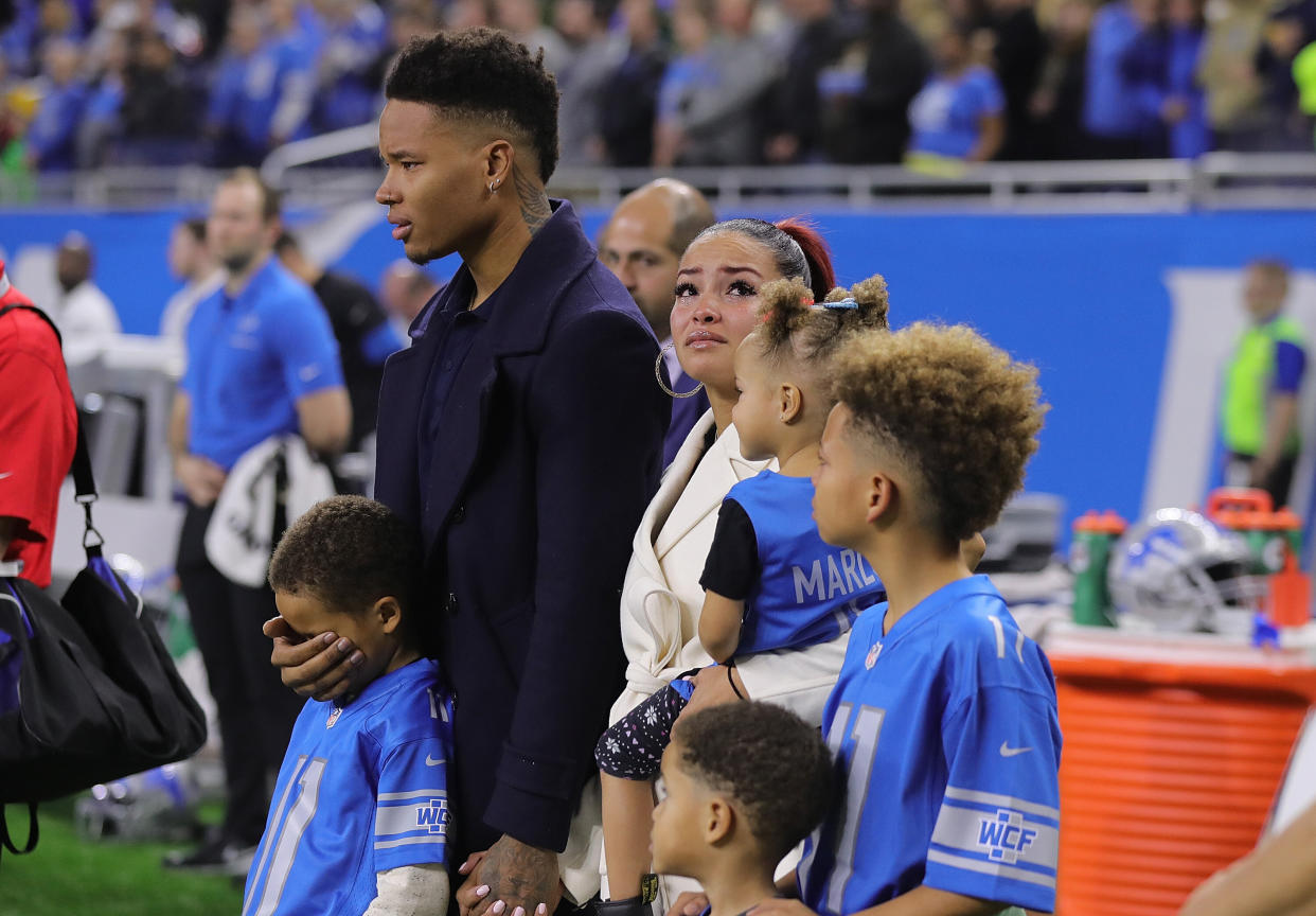 Marvin Jones and his family stand on the sideline in a moment of silence for his infant son, Marlo. (Photo: Leon Halip via Getty Images)