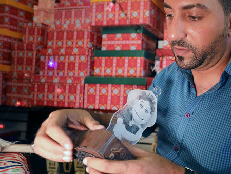 Mohamed Gamal works on a lantern with a portrait of Abla Fahita, a puppet television host, in Cairo, Egypt May 16, 2017. REUTERS/Mohamed Abd El Ghany