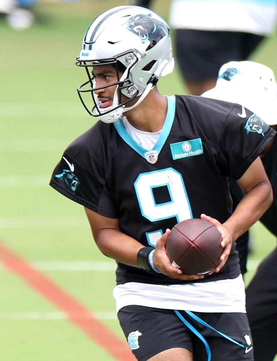 Carolina Panthers quarterback Bryce Young turns to hand the ball off during the team’s OTA practice on Tuesday, June 4, 2024.