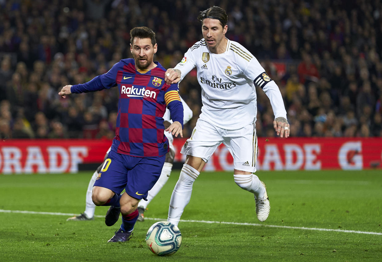 BARCELONA, SPAIN - DECEMBER 18: Lionel Messi of Barcelona is tackled by Sergio Ramos of Real Madrid during the Liga match between FC Barcelona and Real Madrid CF at Camp Nou on December 18, 2019 in Barcelona, Spain. (Photo by Quality Sport Images/Getty Images)