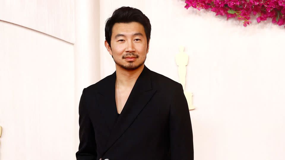 “Barbie” actor Simu Liu wore a black Fendi tuxedo with a low-cut tank top underneath. - Sarah Meyssonnier/Reuters