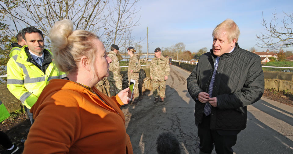 Prime Minister Boris Johnson talks to a woman during a visit to Stainforth, Doncaster, to see the recent flooding.