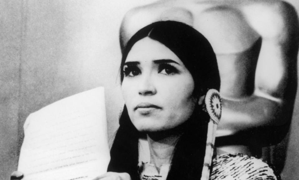 27th March 1973:  Sacheen Littlefeather (Native American actress Maria Cruz) holds a written statement from actor Marlon Brando refusing his Best Actor Oscar on stage at the Academy Awards, Los Angeles, California.  (Photo by Hulton Archive/Getty Images)