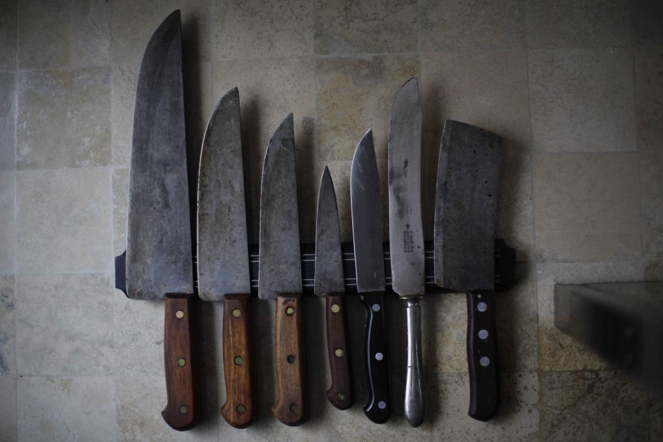 In this Feb.11, 2014 photo, a wall mounted magnetic knife block sustains the collection of kitchen blades in the parent's home of AP photographer Rodrigo Abd, in Buenos Aires, Argentina. Abd grew up in Buenos Aires, and says he’ll always love this city, but it pains him to see it in decline. “I don’t think it’s the golden city that our grandparents thought they lived in. Even if it’s doing much better than other cities in Latin America, I see it just collapsing, all the time,” he said. (AP Photo/Rodrigo Abd)