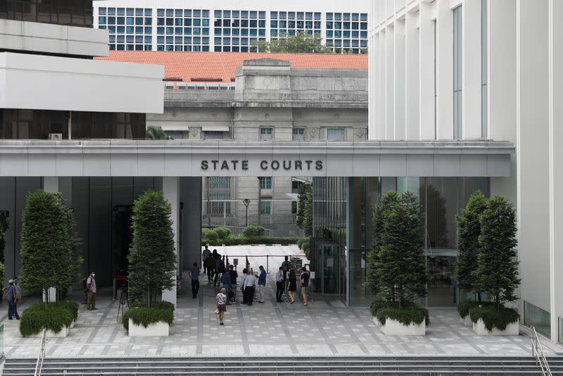 Briton Skea Nigel and partner Agatha Maghesh Eyamalai arrive at the State Courts in Singapore